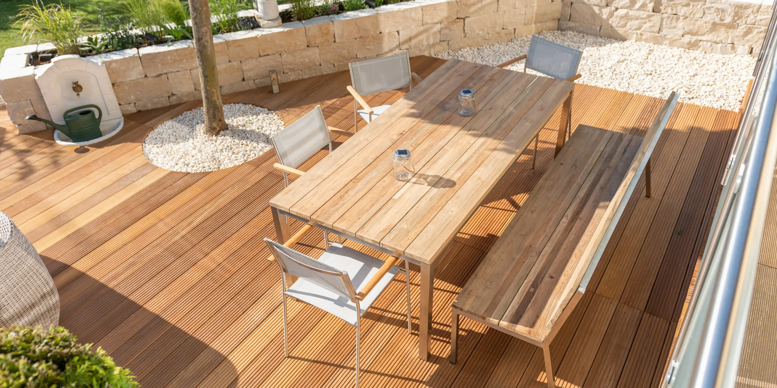 Teak furniture on a modern wooden terrace in summer